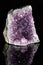 Raw amethyst stone on a black reflective background.