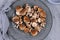Raw Asian edable and medicinal shiitake mushrooms on gray plate