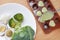 Raw of baby food broccoli, egg and rice in white plate and mashed baby food in container for freezing on wooden board