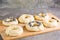 Raw bagels with poppy seeds and sesame seeds on a board on the table. Homemade pastries