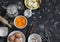 Raw baking ingredients - pumpkin puree, butter, flour, eggs, cream, cinnamon. On a dark background, top view.