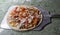 Raw Barbecue pizza is sent to the oven on a spatula, sauce,