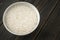 Raw Basmati rice paddy in a white porcelain bowl