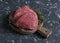 Raw beef chops and fresh thyme on a wooden cutting board