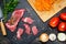 Raw beef cut into slices and vegetables prepared for cooking. View from above