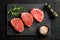 Raw beef Eye Round steaks with spices and rosemary