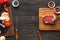 Raw beef filet mignon steaks on wooden board