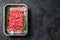 Raw beef Forcemeat, ground meat. Black background. Top view. Copy space