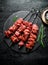 Raw beef kebab on a stone Board with rosemary and spices