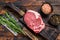 Raw beef meat Club or striploin on the bone steak. Dark wooden background. Top view
