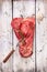 Raw beef with meat fork on old white gray wooden background