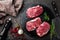 Raw beef meat. Fresh steaks on slate board on black background