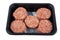 Raw beef meatballs in black plastick tray isolated on white background