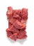 Raw beef pieces isolated on a white background.