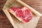 Raw beef Rib steak with bone on wooden board and table