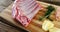 Raw beef ribs and ingredients on wooden board