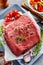 Raw beef rump steak with fresh ingredients