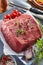 Raw beef rump steak with ingredients