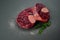 Raw beef shanks with herbs and Himalayan salt on gray background