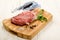 Raw beef shoulder on wooden board with sage