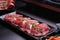 Raw beef slice for barbecue japanese style, yakiniku, meat are being cooked on stove