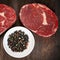 Raw Beef Steaks with Peppercorns