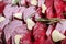 Raw beetroot slices, garlic and rosemary as background, closeup