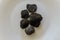 Raw black truffles on a plate