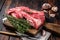 Raw Boneless lamb meat, raw neck meat on wooden board. Black background. Top view