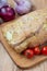 Raw boneless shoulder square cut on a wooden cutting board and wooden table