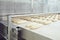 Raw bread is making on the automatic equipment line in the bakery.