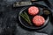 Raw burgers cutlets, organic ground beef meat. Black background. Top view. Copy space