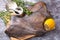 Raw butchered flounder on a cutting board with herbs and spices.