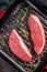 Raw Cap Rump steak, marbled beef meat on a grill skillet. Dark background. Top view