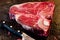 Raw Cattle Porterhouse, T Bone Steak Aged dry bone steak on a chopping board