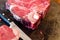 Raw Cattle Porterhouse, T Bone Steak Aged dry bone steak on a chopping board