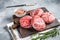 Raw Caul Fat Meatballs burger cutlets, fresh meat. Gray background. Top view