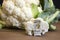 Raw cauliflower head and floret with nutritional fact label on w