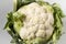 Raw cauliflower on a table ready to be cleaned and cooked.