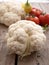 Raw cauliflower, whole vegetable on the plank surface