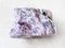 raw charoite stone on white