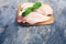 Raw chicken breasts and spices on wooden cutting board, close up