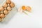 Raw chicken eggs and wheat spikes on white table. Space for text