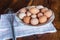 Raw chicken eggs on white plate with whisk on wooden background. Ready to start the cooking concept