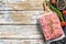 Raw chicken, Turkey ground meat on a chopping Board. Organic forcemeat. White background. Top view. Copy space