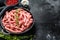 Raw chicken, Turkey ground meat in a pan. Organic forcemeat, mince. Black background. Top view. Copy space