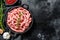 Raw chicken, Turkey ground meat in a pan. Organic forcemeat, mince. Black background. Top view. Copy space