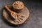 Raw chickpeas wooden scoop and bowl on a stump board, seen from the front. Selective focus,copy space