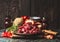 Raw chopped Beef goulash of young bulls with vegetables and cooking ingredients on dark rustic kitchen table