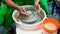 A raw clay pot in the hands of a potter. Workshop in the pottery workshop